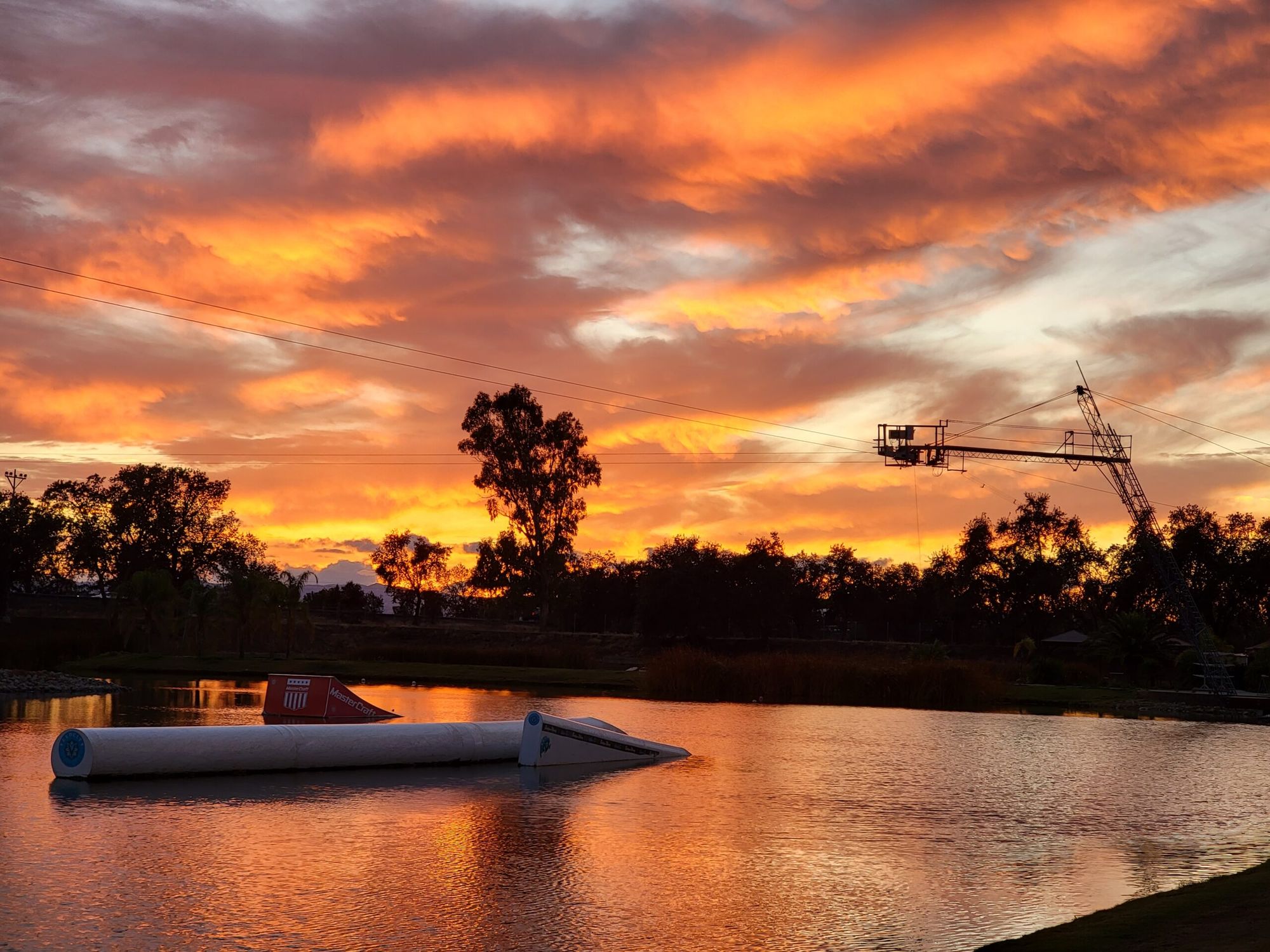 Guests enjoying the white sand beach and lake at Velocity Island